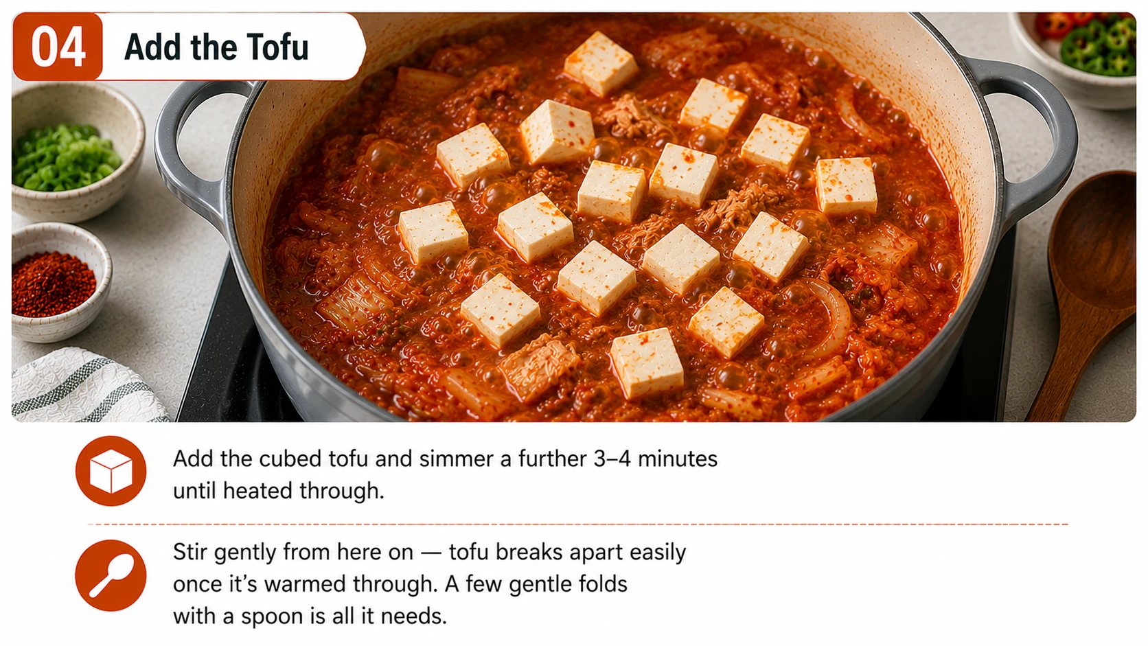 Adding cubed tofu to spam kimchi jjigae