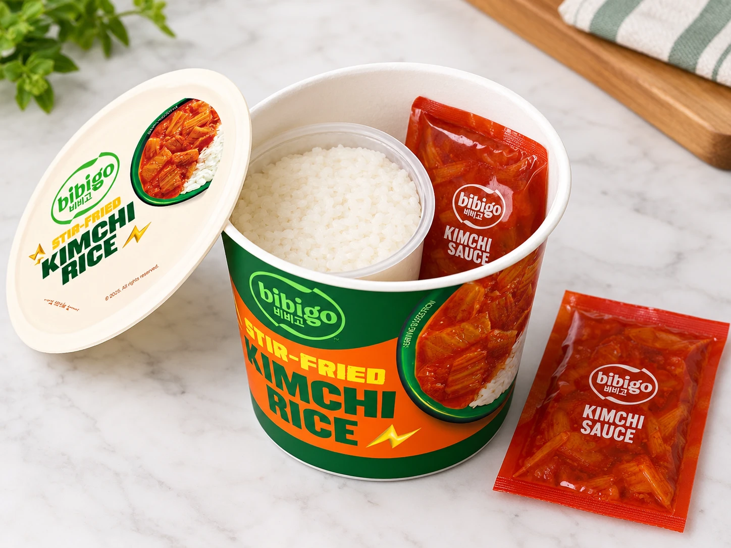 Bibigo kimchi rice bowl opened to show the rice bowl and the kimchi sauce packet